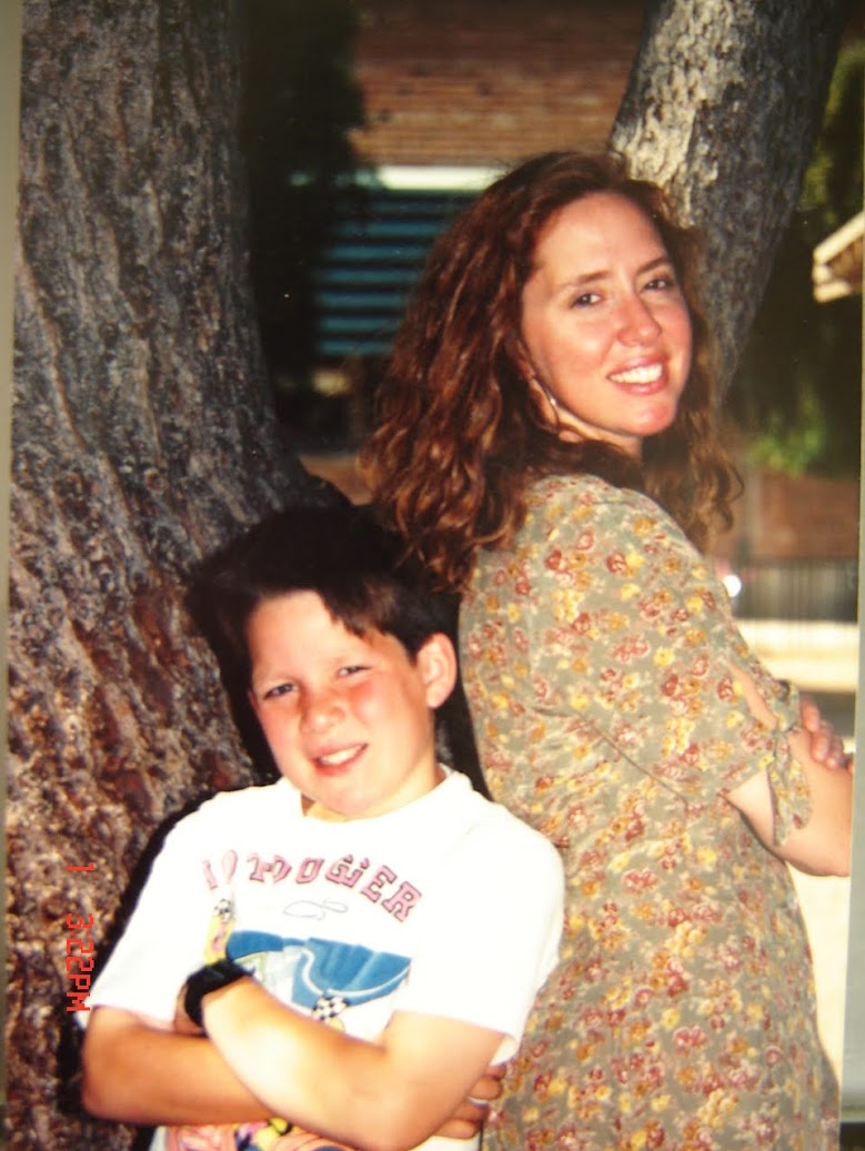 Scott as a boy standing beside his mother beneath a tree